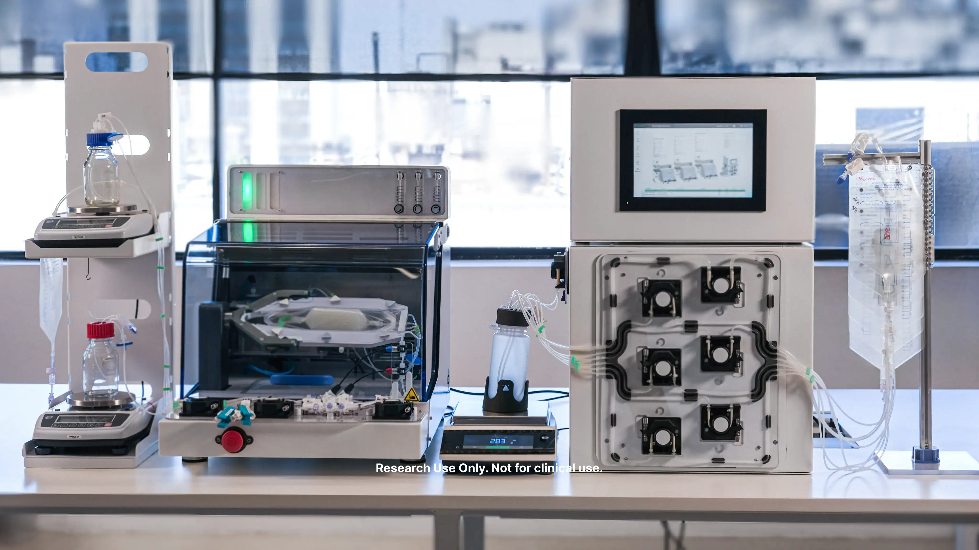 Front view of a high-throughput bioprocessor on a lab bench, showing a digital control interface, a modular pump array, and a closed-loop bioreactor chamber.